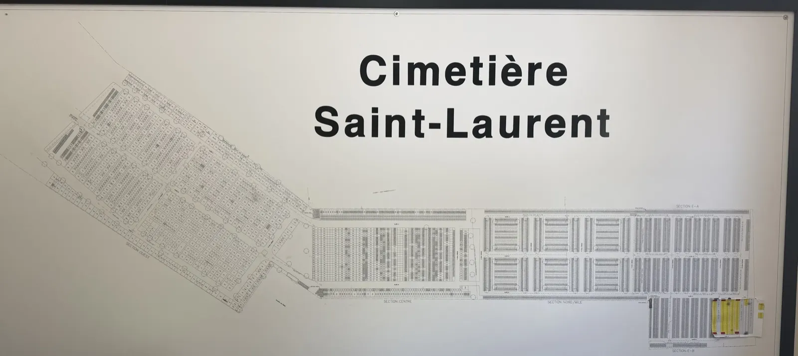 The cemetery's paper plan hanging on the office wall